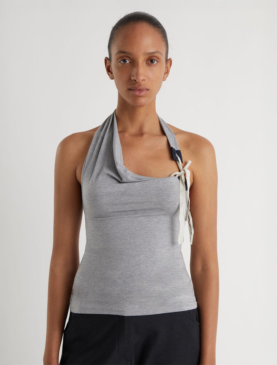 SIMULET-Grey halter top with a patch detail featuring an eyelet and adjustable strap