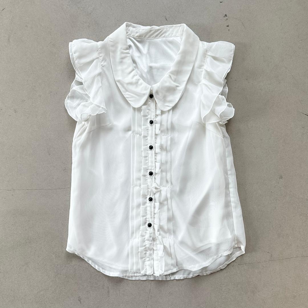 White ruffle sleeveless blouse