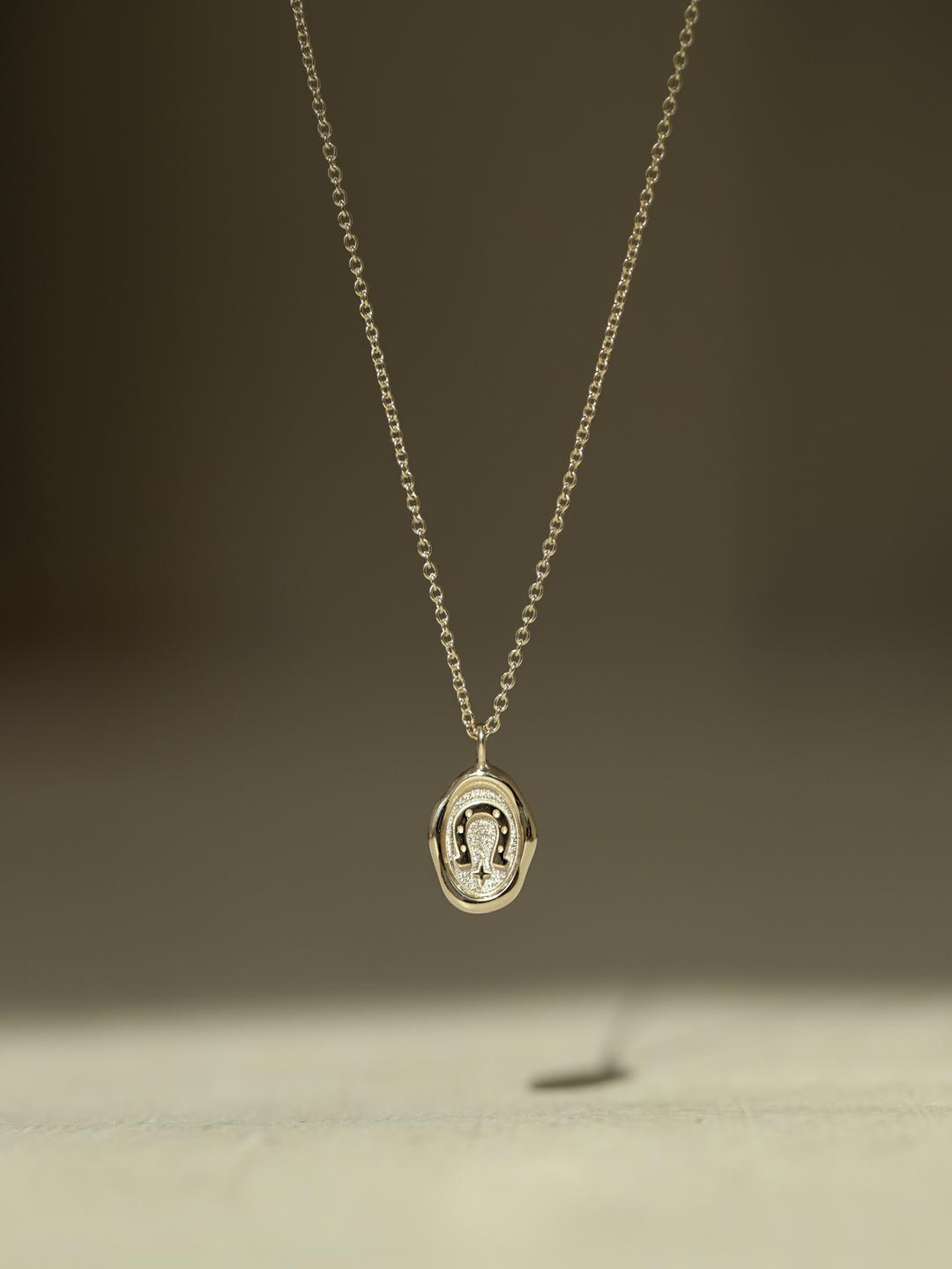 oval wax seal symbol necklace.
