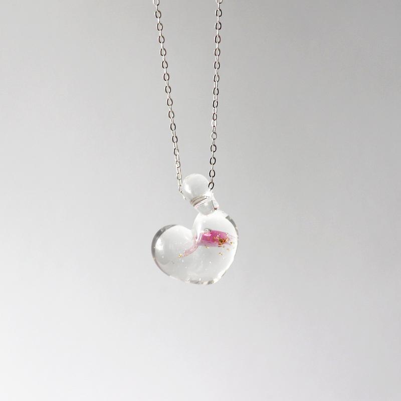 glass heart necklace. clear pink gold